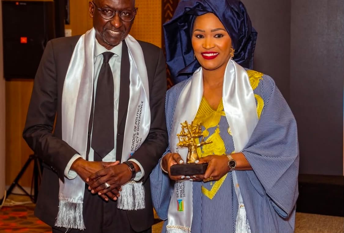An SPPG Senegal graduate holding her award beside a member of faculty